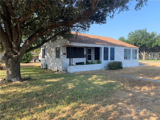 rear view of property featuring crawl space and a lawn