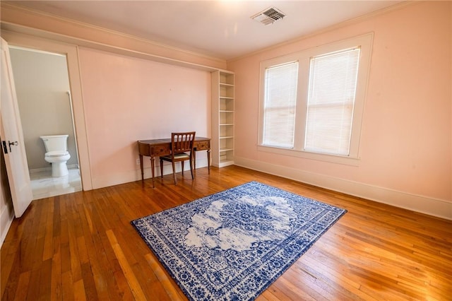 1107 N Adams St, Beeville, TX 78102 - interior space featuring hardwood / wood-style floors, baseboards, ornamental molding, and built in features