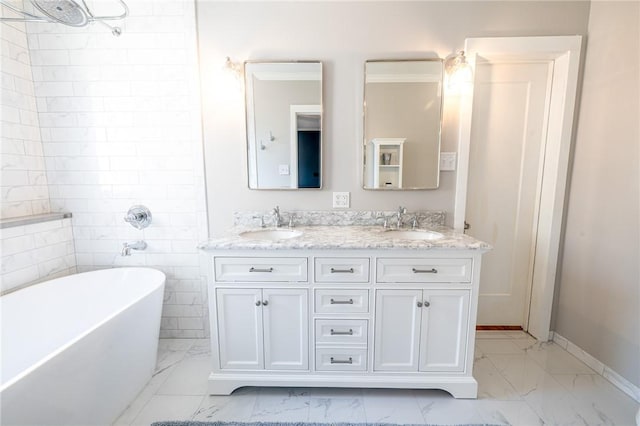 1107 N Adams St, Beeville, TX 78102 - bathroom with marble finish floors, a soaking tub, double vanity, and baseboards