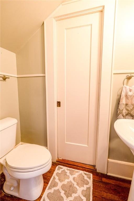 1107 N Adams St, Beeville, TX 78102 - bathroom with toilet and wood finished floors