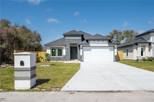 prairie-style house with stone siding, fence, concrete driveway, a front yard, and an attached garage