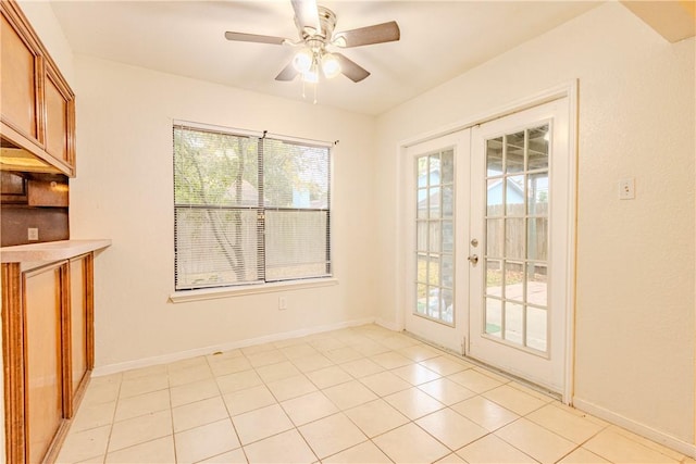 entryway with french doors, ceiling fan, and light tile patterned flooring