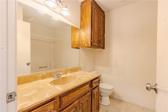 bathroom featuring vanity, tile patterned floors, and toilet