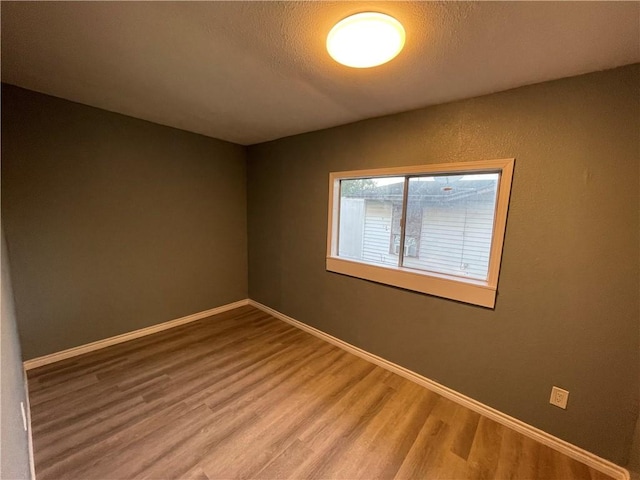 4313 Molina Dr, Corpus Christi, TX 78416 - spare room featuring light wood-style flooring, baseboards, and a textured ceiling