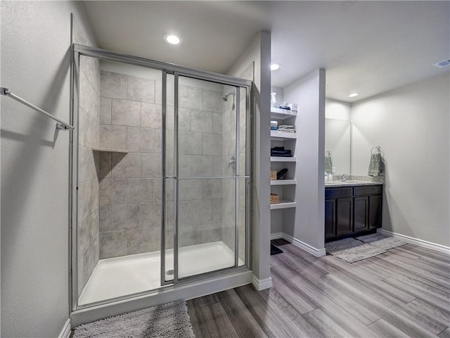 2693 Excelsior Blvd, Corpus Christi, TX 78415 - bathroom featuring a shower stall, wood finished floors, vanity, and recessed lighting