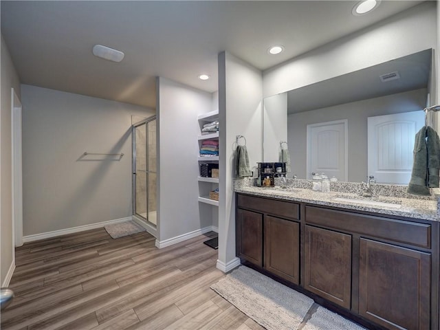 2693 Excelsior Blvd, Corpus Christi, TX 78415 - bathroom featuring double vanity, a stall shower, wood finished floors, recessed lighting, and a closet