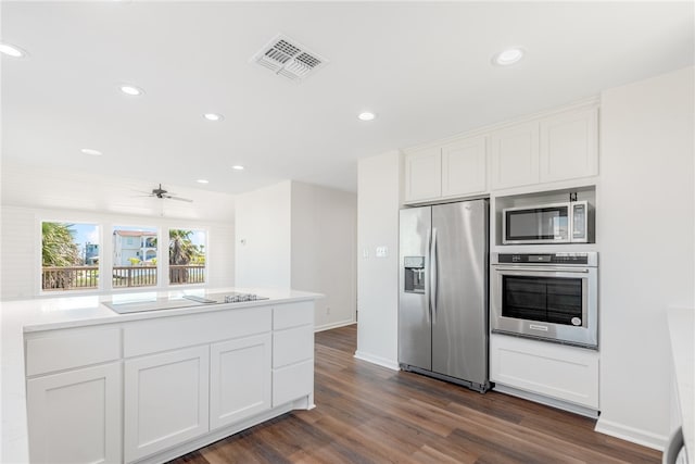 kitchen featuring white cabinets, appliances with stainless steel finishes, dark hardwood / wood-style floors, and ceiling fan