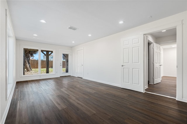 unfurnished room with dark hardwood / wood-style floors