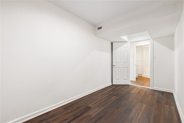 spare room featuring dark wood-type flooring