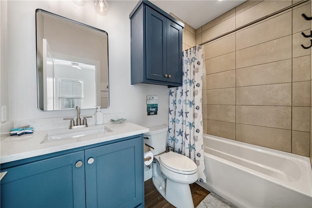 full bathroom featuring toilet, vanity, wood finished floors, and shower / bathtub combination with curtain