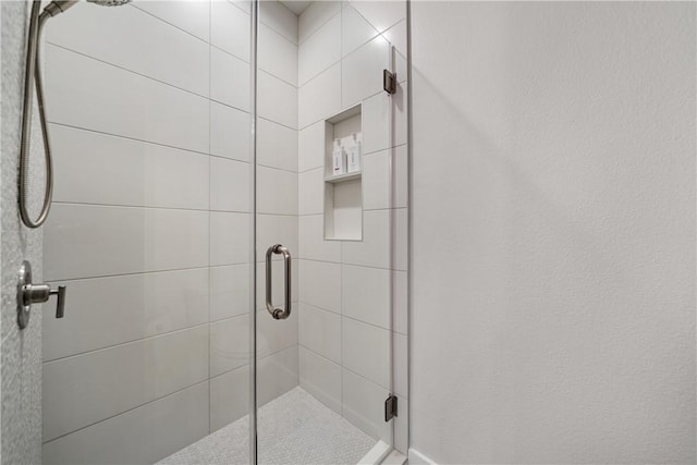 bathroom with a shower stall