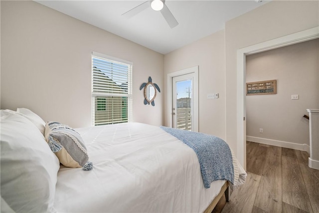 bedroom featuring baseboards, a ceiling fan, wood finished floors, and access to outside