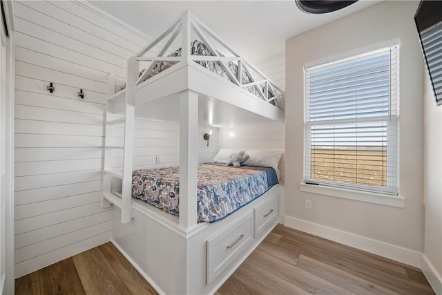 bedroom with wood finished floors and baseboards