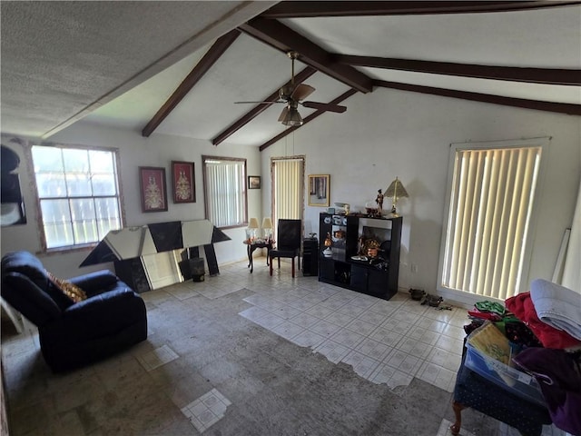 living room featuring lofted ceiling with beams and a ceiling fan