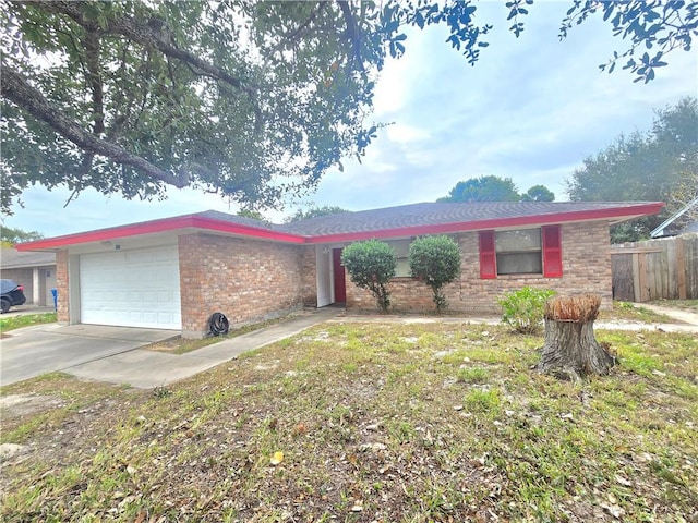 ranch-style home featuring a garage, fence, brick siding, and driveway