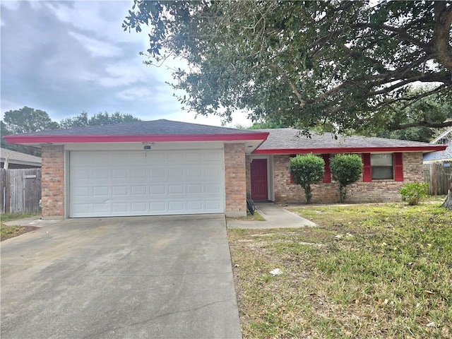 single story home featuring brick siding, an attached garage, concrete driveway, and fence