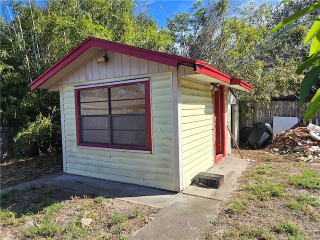 view of outbuilding with an outbuilding and fence