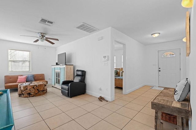 living room featuring visible vents, baseboards, and light tile patterned flooring