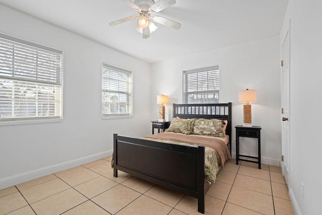 bedroom featuring light tile patterned floors, baseboards, and a ceiling fan