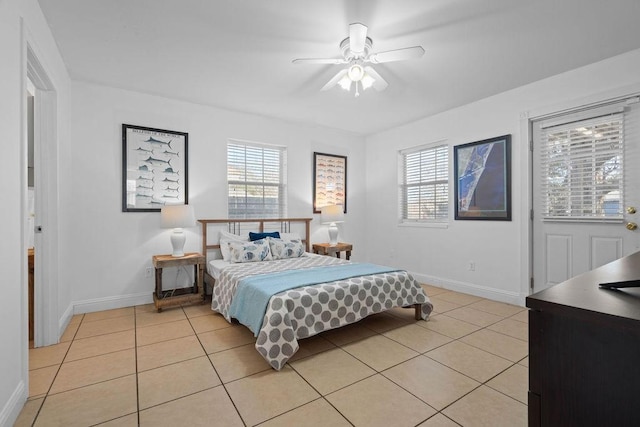 bedroom featuring light tile patterned floors, ceiling fan, and baseboards