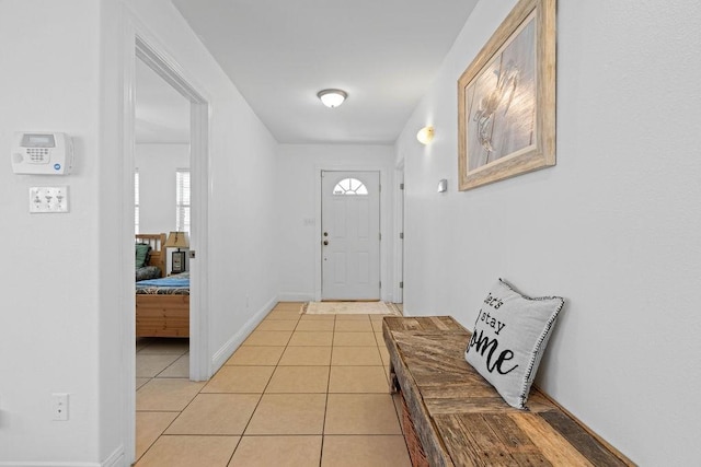 foyer featuring light tile patterned floors and baseboards