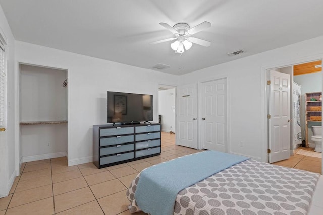 bedroom with light tile patterned floors, a ceiling fan, visible vents, and baseboards