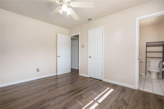 1576 Vineyard, Ingleside, TX 78362 - unfurnished bedroom with wood finished floors, ensuite bath, baseboards, and visible vents
