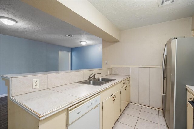 1576 Vineyard, Ingleside, TX 78362 - kitchen featuring freestanding refrigerator, a sink, visible vents, dishwasher, and a peninsula