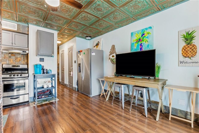 3938 Surfside Blvd Unit 2244, Corpus Christi, TX 78402 - kitchen with under cabinet range hood, wood finished floors, an ornate ceiling, and appliances with stainless steel finishes