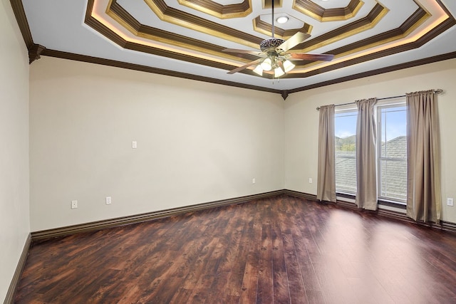 unfurnished room featuring a tray ceiling, ceiling fan, dark hardwood / wood-style floors, and ornamental molding