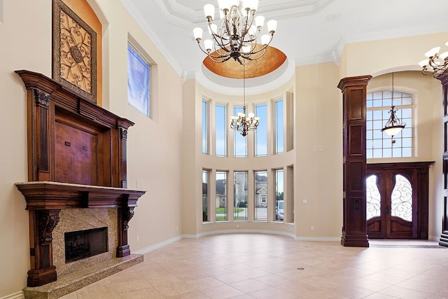 entryway with a fireplace, a wealth of natural light, and ornamental molding