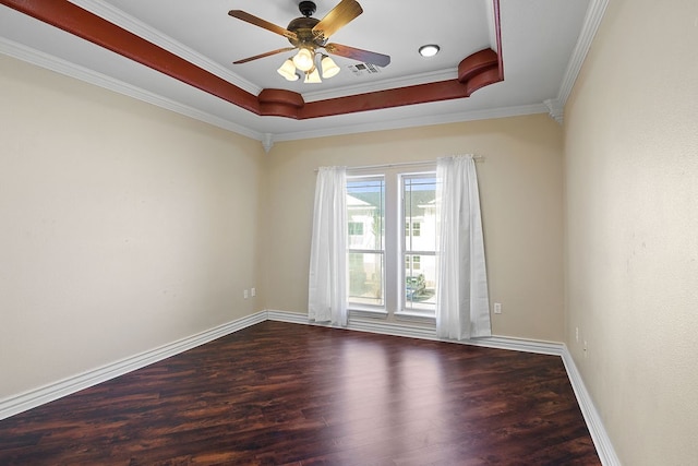 spare room featuring a tray ceiling, ceiling fan, ornamental molding, and hardwood / wood-style flooring