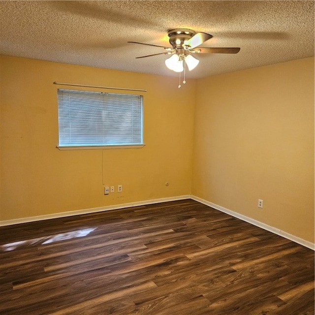 empty room with a textured ceiling, dark hardwood / wood-style floors, and ceiling fan