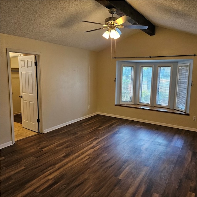 empty room with ceiling fan, dark hardwood / wood-style floors, a textured ceiling, and vaulted ceiling with beams