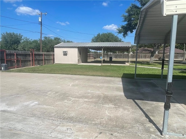 view of patio / terrace featuring a carport and a storage unit