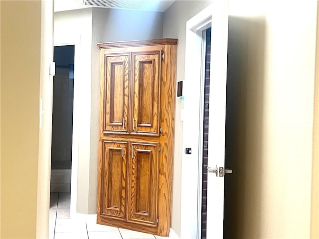 hallway featuring light tile patterned flooring