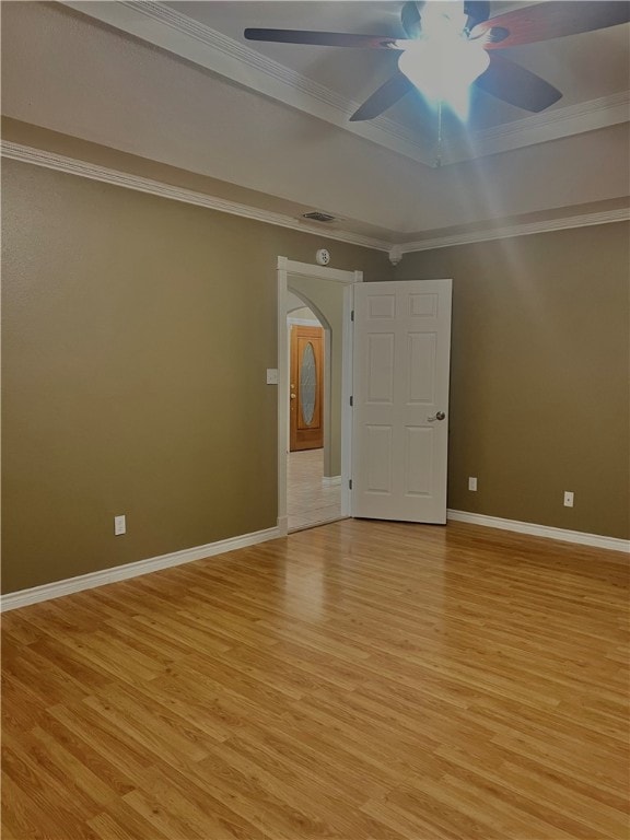 spare room featuring ceiling fan, ornamental molding, and light hardwood / wood-style floors