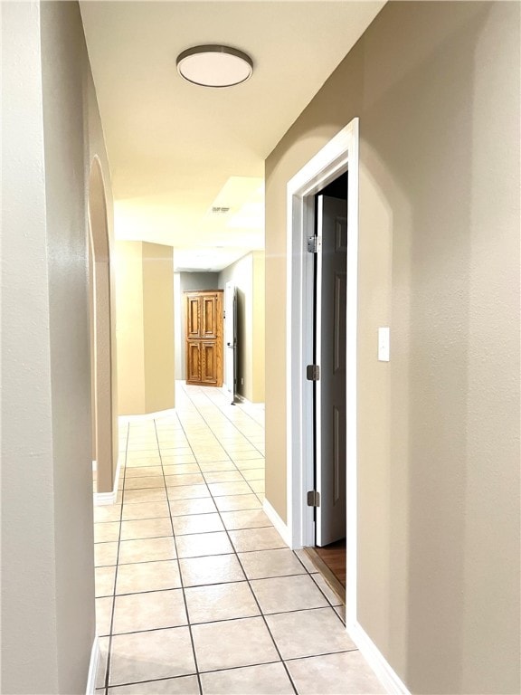 corridor with light tile patterned floors