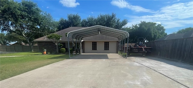 view of front of property with a front yard and a carport