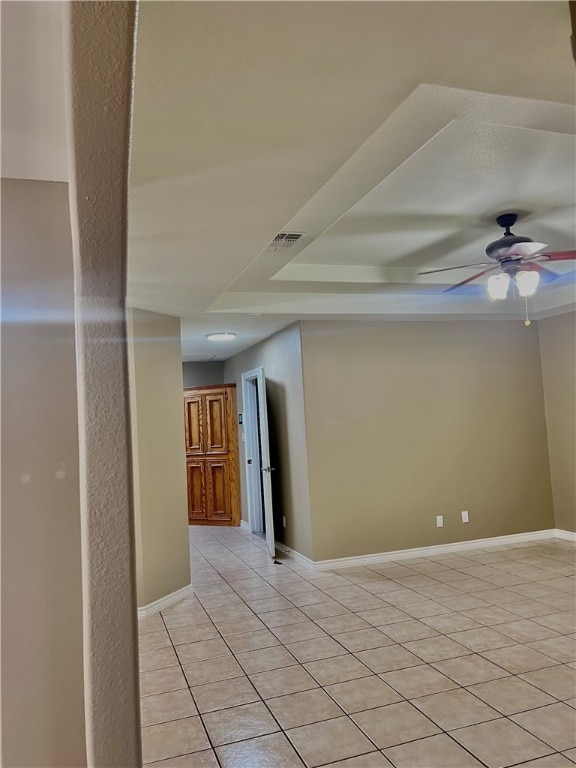 tiled empty room with ceiling fan