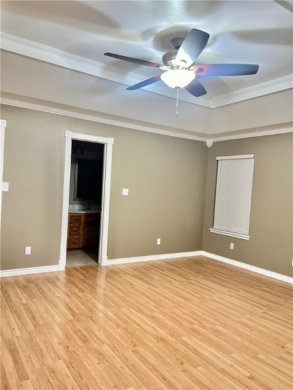 spare room featuring ornamental molding, ceiling fan, and light hardwood / wood-style floors