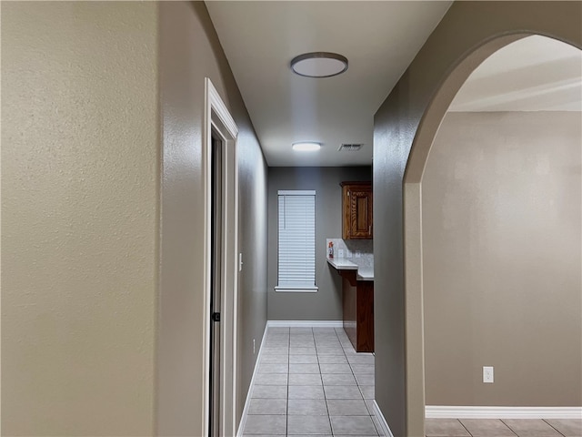 hallway with light tile patterned floors