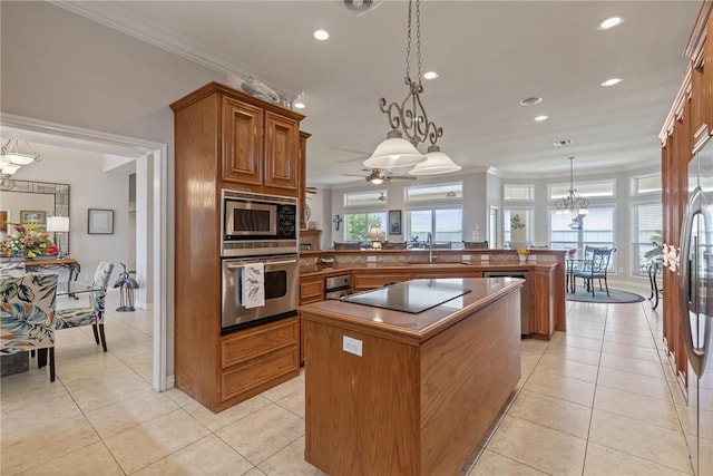 1618 Cantera Bay, Corpus Christi, TX 78418 - kitchen with stainless steel appliances, brown cabinets, a kitchen island, a peninsula, and a chandelier