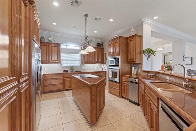 1618 Cantera Bay, Corpus Christi, TX 78418 - kitchen with a sink, stainless steel appliances, brown cabinetry, tasteful backsplash, and ornamental molding