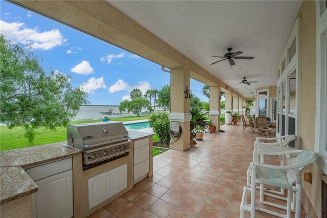 1618 Cantera Bay, Corpus Christi, TX 78418 - view of patio featuring a grill, an outdoor kitchen, a ceiling fan, and a water view
