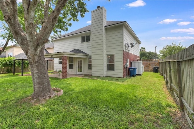 6709 Pembrock, Corpus Christi, TX 78414 - rear view of property featuring a chimney, a patio area, brick siding, and roof with shingles