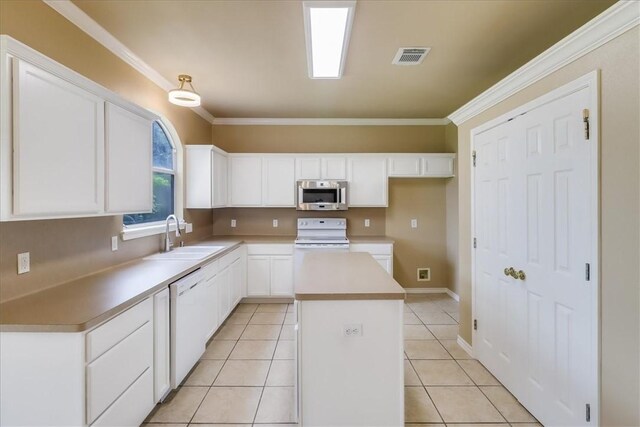 6709 Pembrock, Corpus Christi, TX 78414 - kitchen with white appliances, a sink, a kitchen island, white cabinetry, and ornamental molding