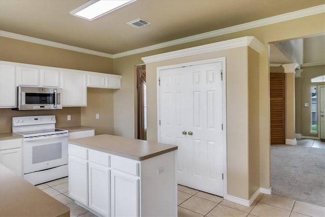 6709 Pembrock, Corpus Christi, TX 78414 - kitchen featuring stainless steel microwave, white range with electric cooktop, light tile patterned flooring, ornamental molding, and white cabinets