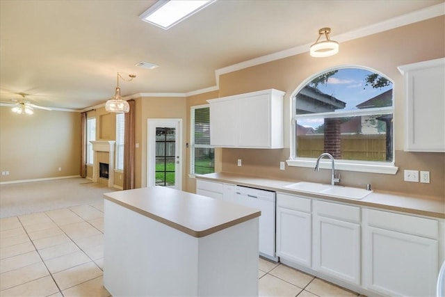 6709 Pembrock, Corpus Christi, TX 78414 - kitchen with white dishwasher, a sink, a center island, a fireplace, and light countertops