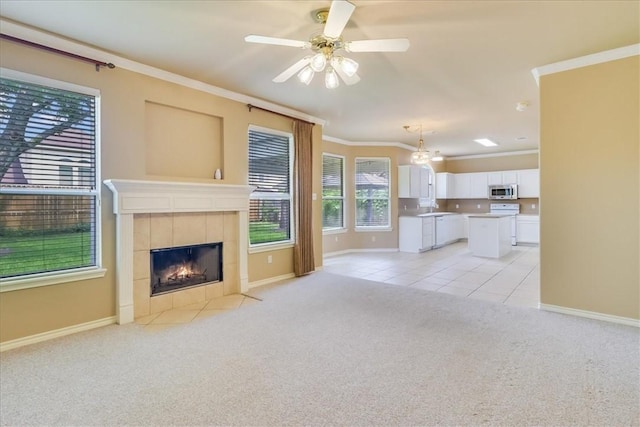 6709 Pembrock, Corpus Christi, TX 78414 - unfurnished living room with light carpet, ornamental molding, baseboards, a fireplace, and ceiling fan